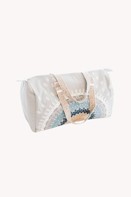 White duffel bag with floral pattern on a white background