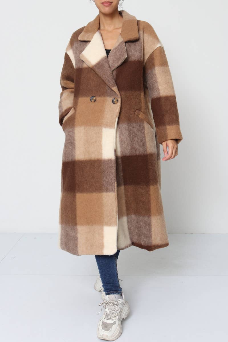 Person wearing a long, plaid coat with brown, beige, and blue pattern on a white background