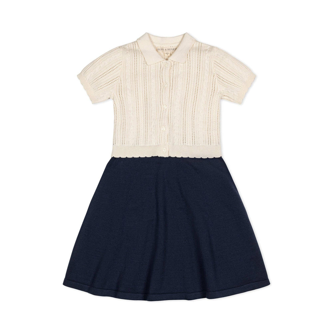 Two-tone dress with cream top and navy skirt on a white background