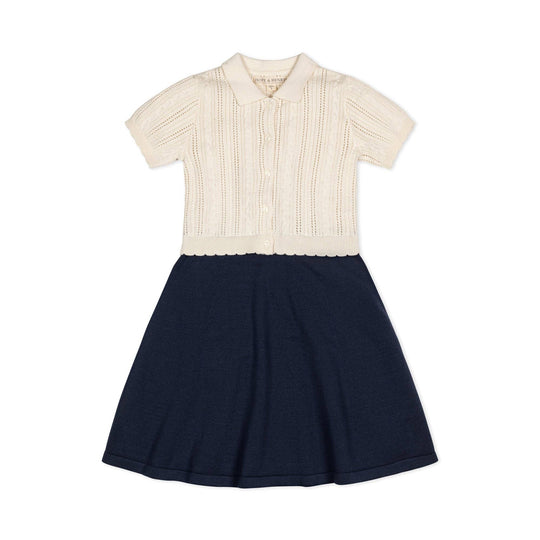 Two-tone dress with cream top and navy skirt on a white background