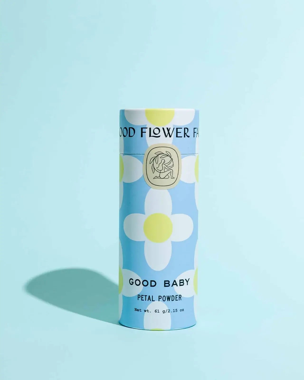 Cylindrical product packaging with floral design and text on a light blue background