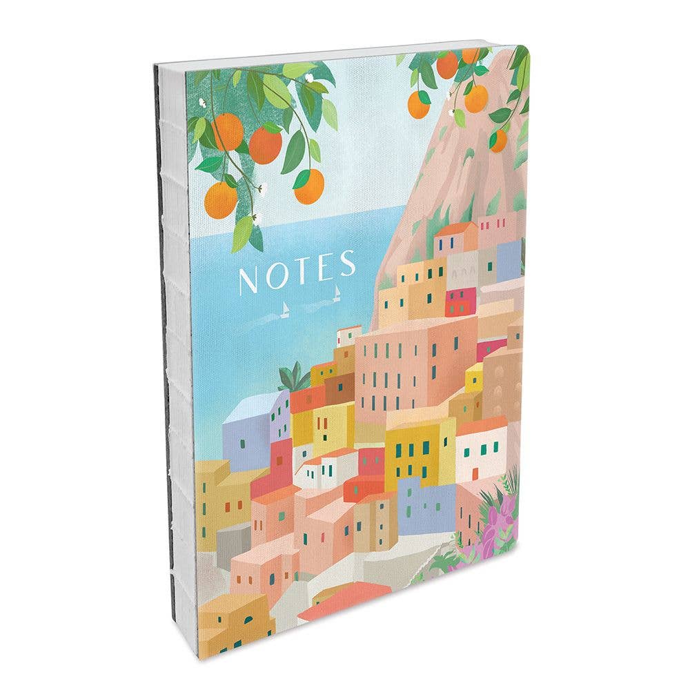Notebook with colorful illustration of a coastal town and orange trees on the cover