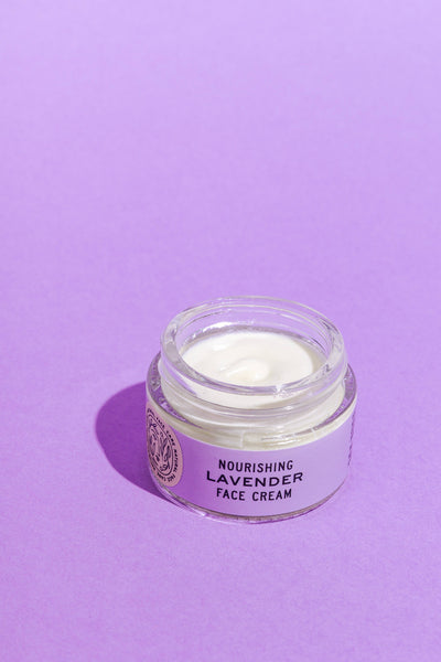 Jar of nourishing lavender face cream on a purple background