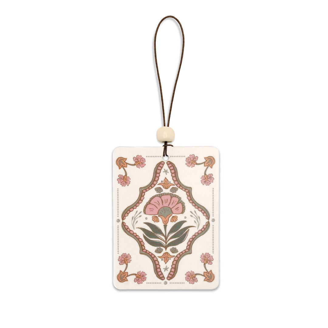 Decorative car freshener with floral design on a white background