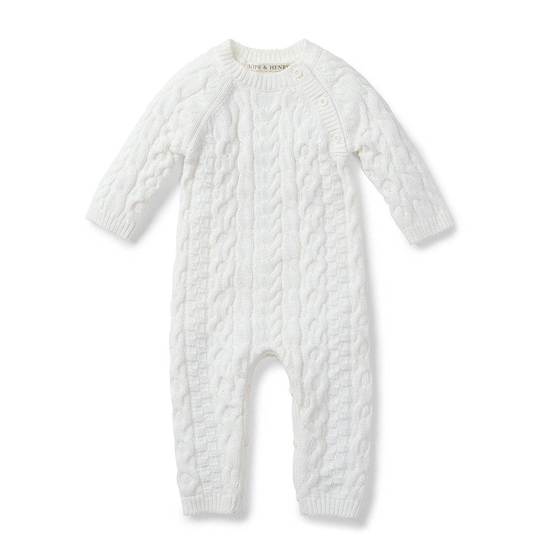 White cable knit baby romper on a white background