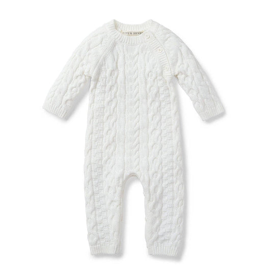 White cable knit baby romper on a white background